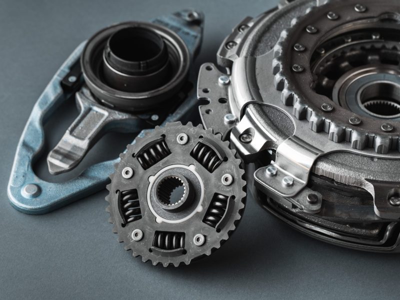 New clutch kit of the automatic gearbox DSG prepared to replace. Spare parts for a modern car isolated on grey background. Car repair and service concept