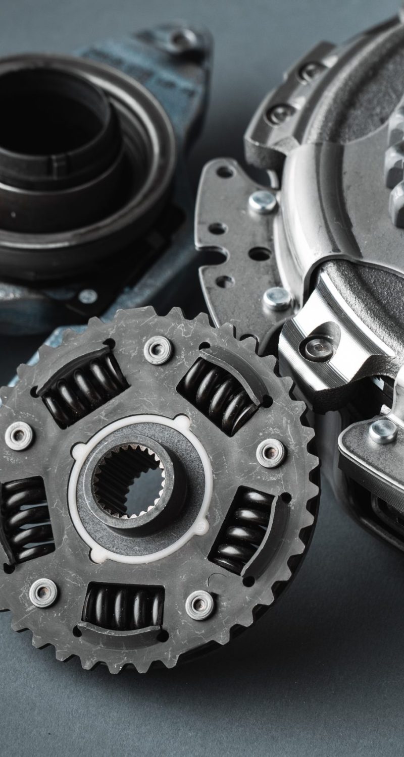 New clutch kit of the automatic gearbox DSG prepared to replace. Spare parts for a modern car isolated on grey background. Car repair and service concept